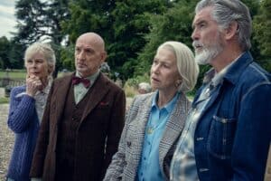 Thoughtful elderly family gathering outdoors, focusing on serious conversation amid lush green park, portraying close-knit moments and multigenerational bonds in natural setting.